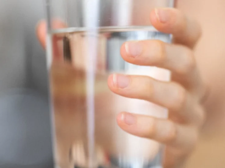 hand holding a glass of water hand holding a glass of water